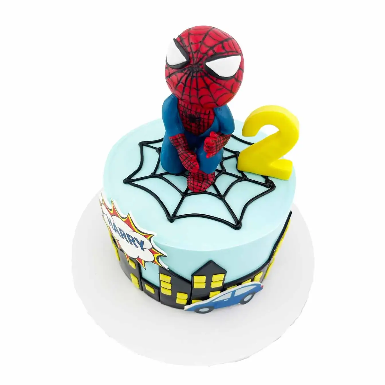 Our Spiderman cake with city skyline design features a smooth blue fondant cake with a black city skyline made of fondant. Topped with a cartoon Spiderman figurine, it's perfect for any Spiderman fan's celebration!